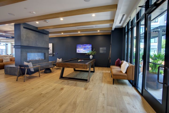Apartment game room and fireplace lounge photographed for amenity marketing
