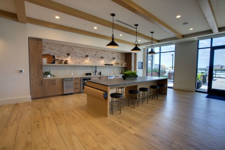 Modern community kitchen and island photographed for apartment marketing