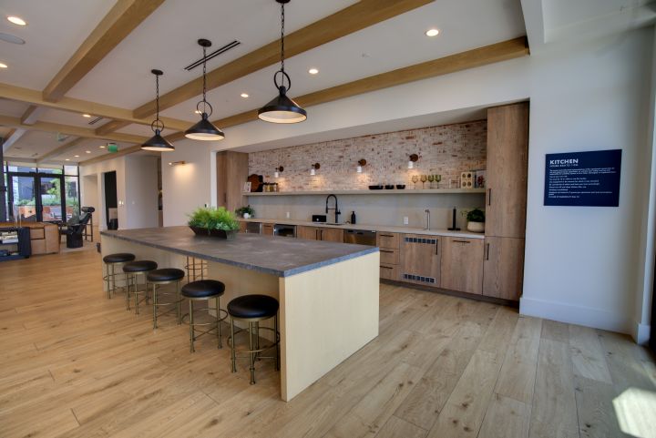 Modern apartment kitchen island and dining space photographed for leasing